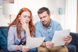young caucasian couple having debt problems after home expenses